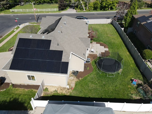 Contemporary residence featuring a pitched roof with extensive solar paneling