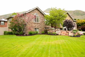 Stone veneer exterior featuring an arched window