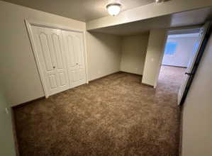 Carpeted interior space featuring neutral wall tones