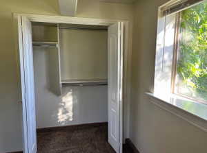 Built-in closet featuring shelving and chrome hanging rods