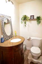 Vanity featuring an integrated sink, polished chrome faucet, and stone countertop