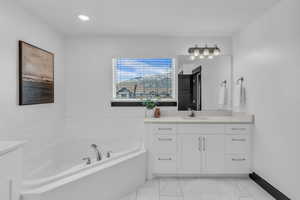 Corner soaking tub with deck-mounted chrome fixtures
