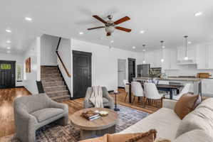 Open-concept living space featuring wood-finish flooring, recessed lighting, and a ceiling fan