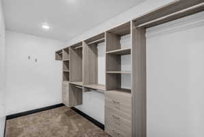 Built-in closet system featuring multiple shelving units, hanging rods, and integrated drawers