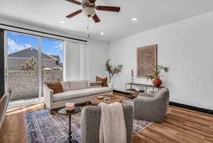 Open living area featuring wood-finish flooring, recessed lighting, and a ceiling fan
