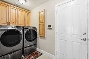 Laundry Area on Main Floor with Cabinets & Ironing Board