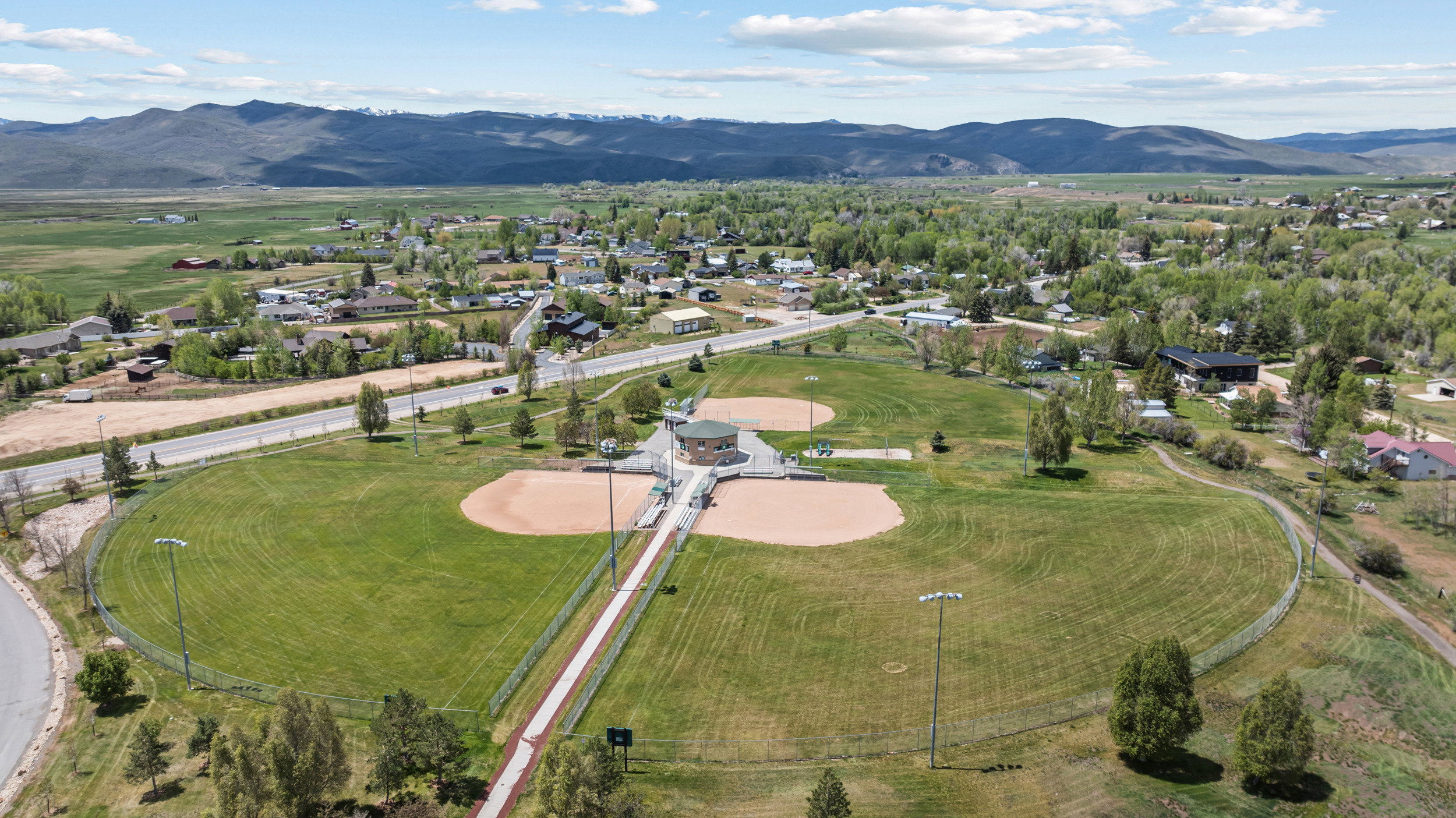 Expansive community sports complex featuring multiple baseball fields with manicured outfields and infields