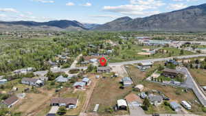 Expansive property featuring a single-story residence and detached garage, set against a backdrop of distant mountains