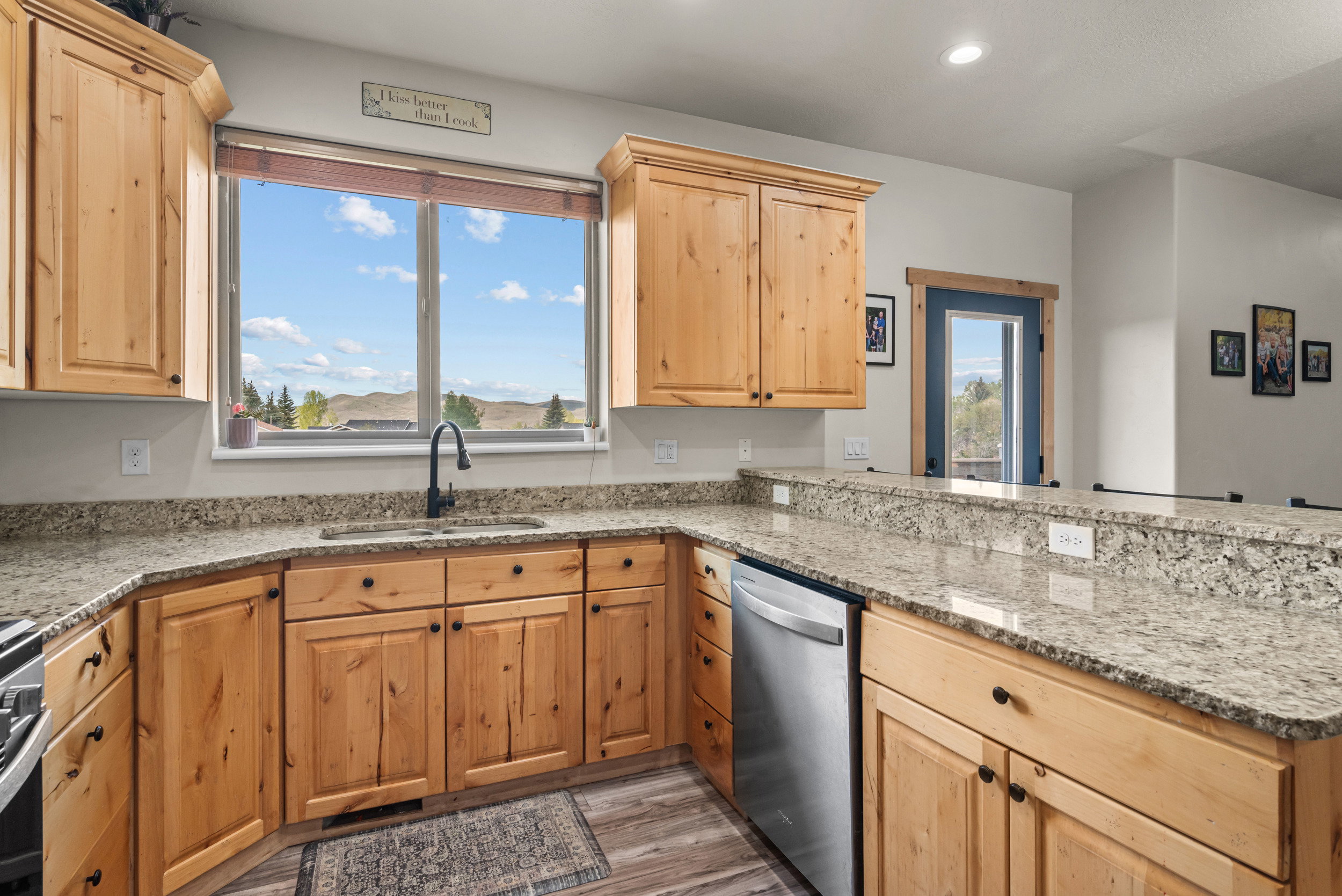 Kitchen featuring light wood cabinetry and granite-style countertops