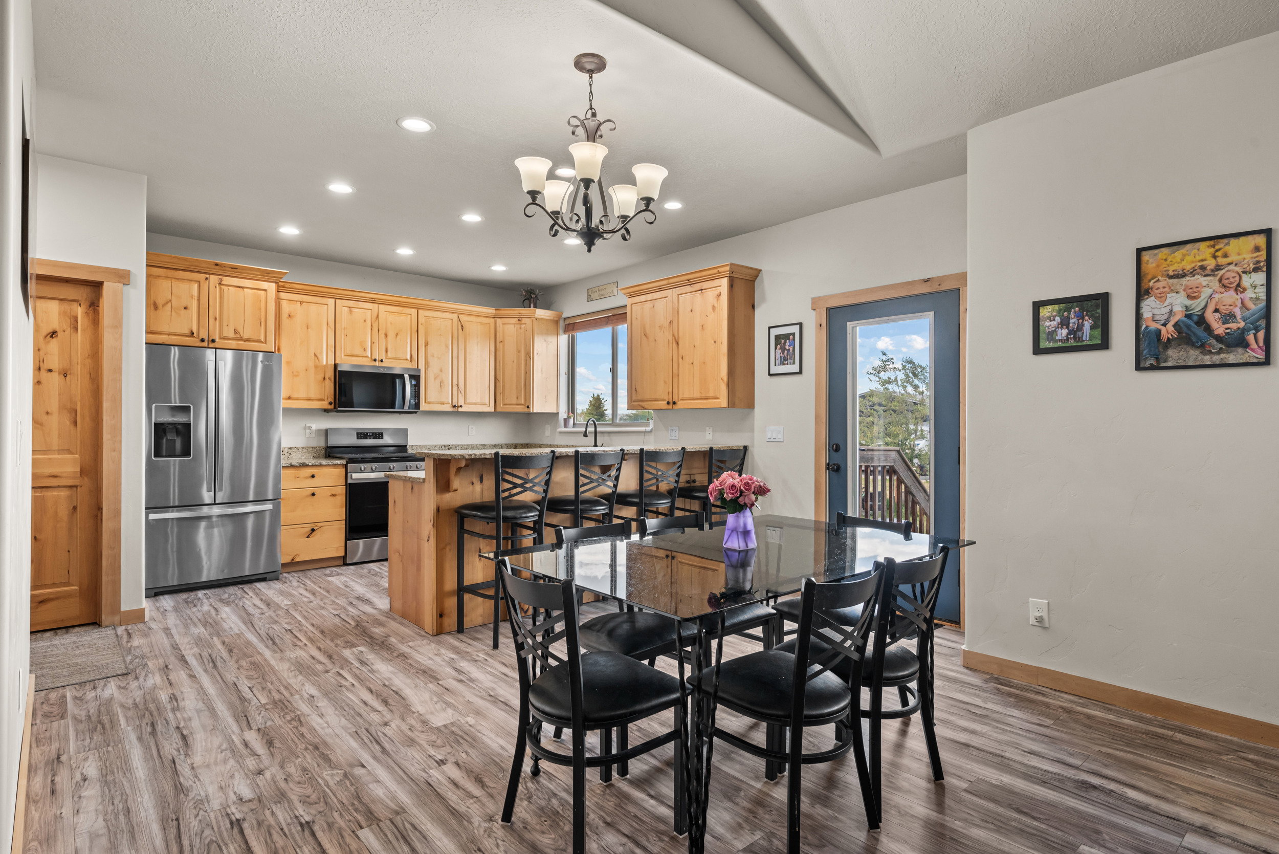 Spacious kitchen featuring wood cabinetry, stainless steel appliances, and wood-finish flooring