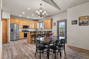 Spacious kitchen featuring wood cabinetry, stainless steel appliances, and wood-finish flooring