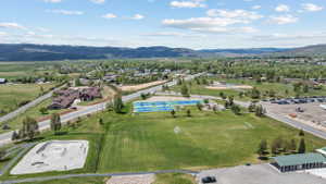 Expansive green spaces featuring multiple sports courts, a baseball field, and a skate park