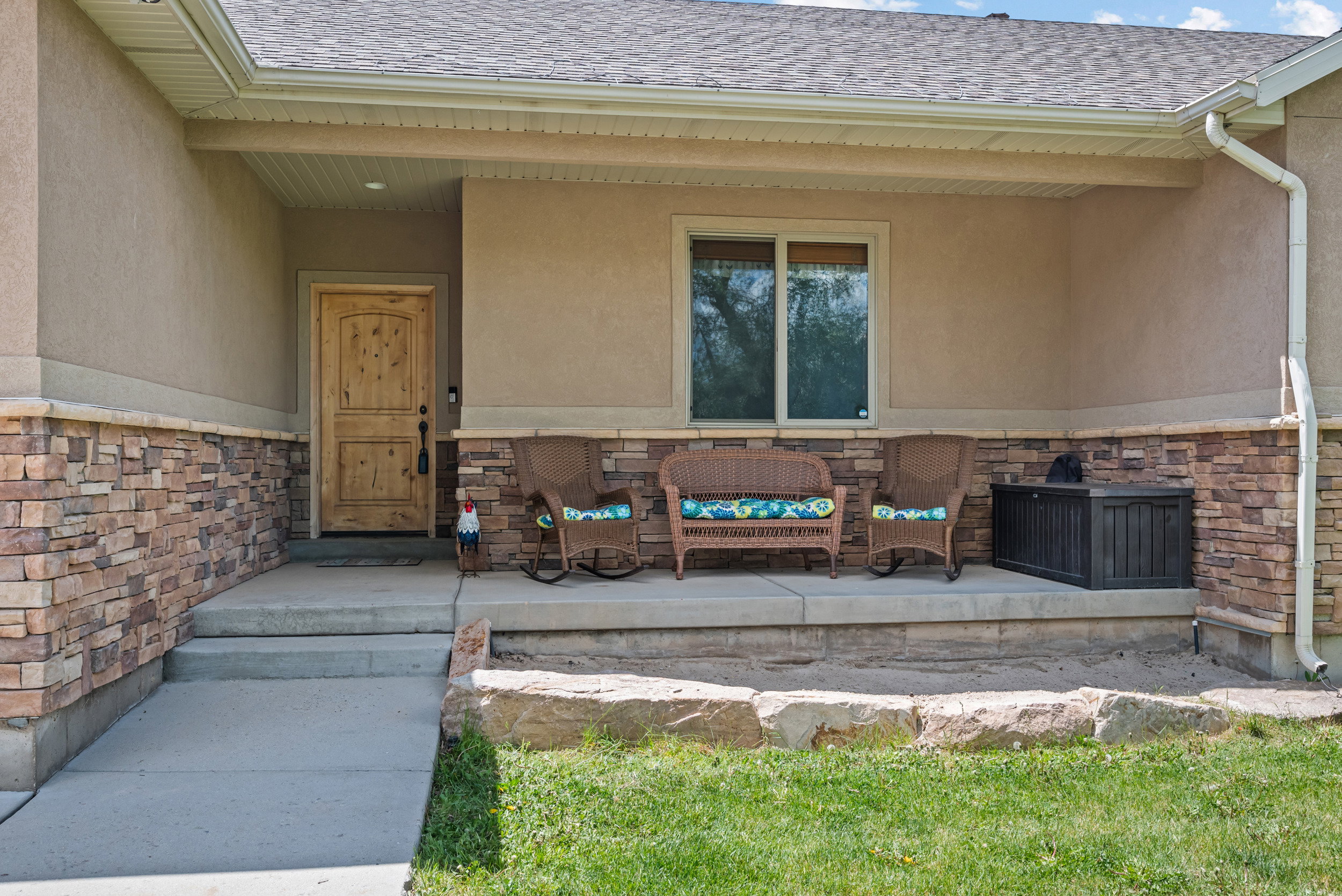 Exterior facade featuring a covered front porch with stone veneer accents