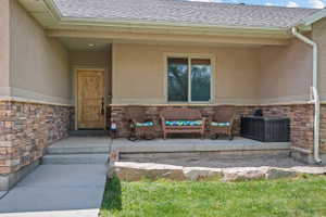 Exterior facade featuring a covered front porch with stone veneer accents