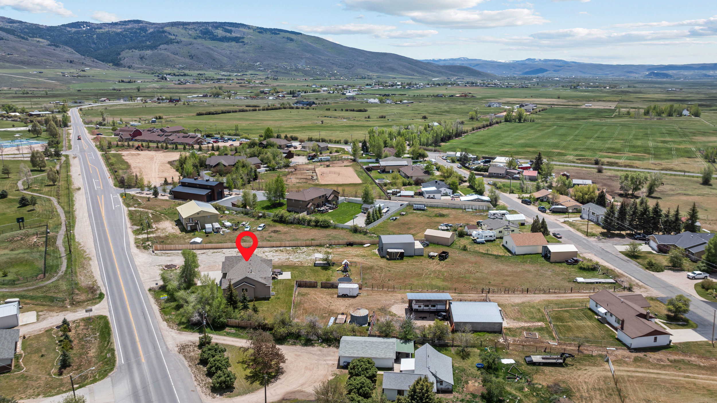 Aerial perspective showcasing a single-family residence with a light-colored roof