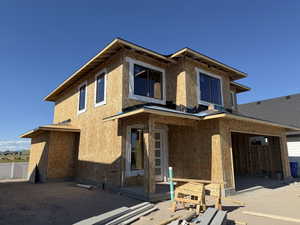Two-story residential structure featuring a newly framed exterior