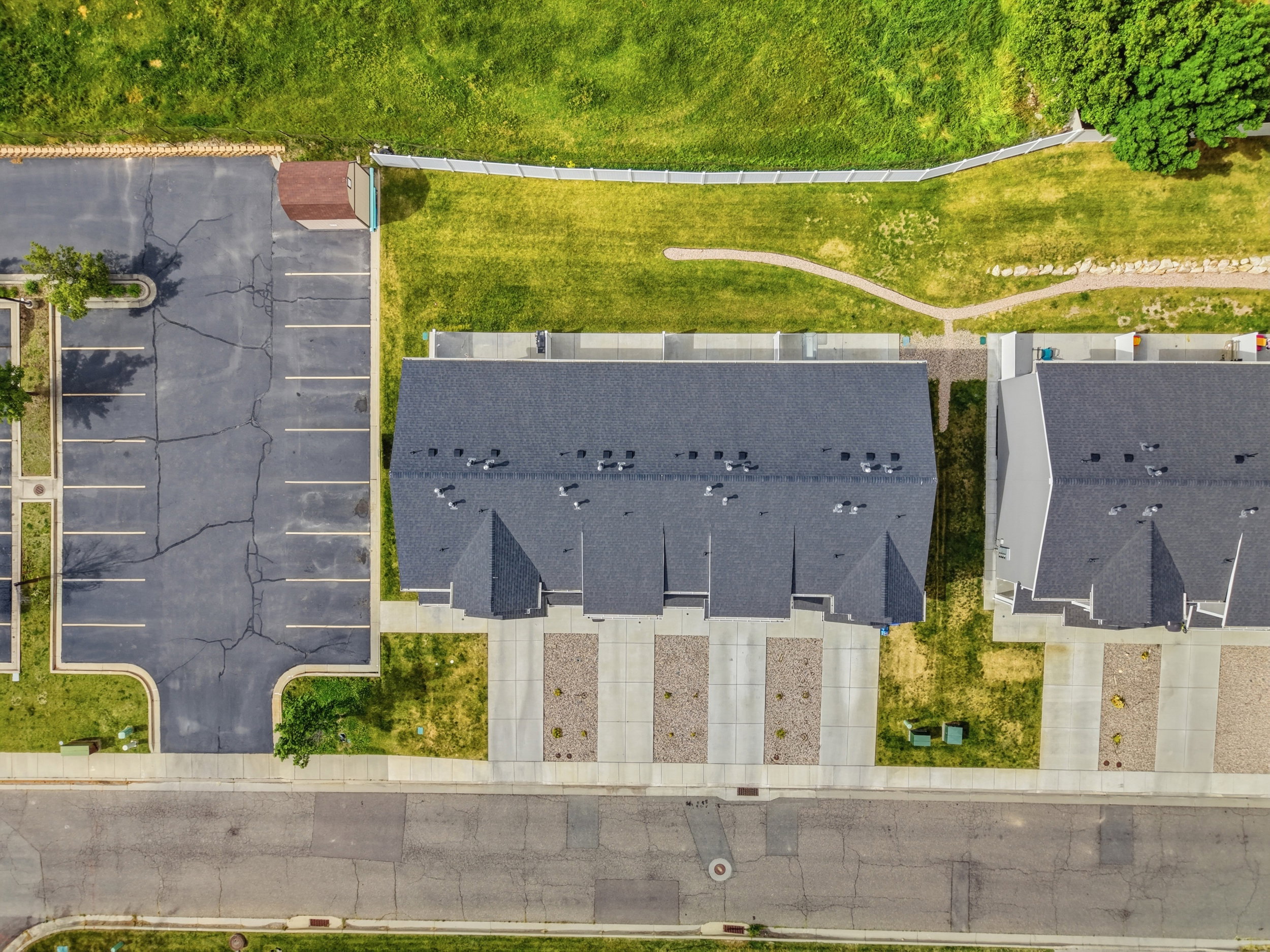 Aerial perspective showcasing new construction townhomes with dark shingle roofing