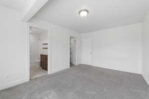 Spacious room with light gray carpet and white walls
