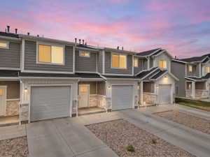 Townhome exterior featuring horizontal siding and white trim accents
