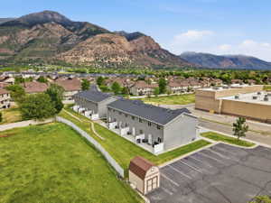 Modern townhome exteriors featuring light gray siding and dark shingle roofs