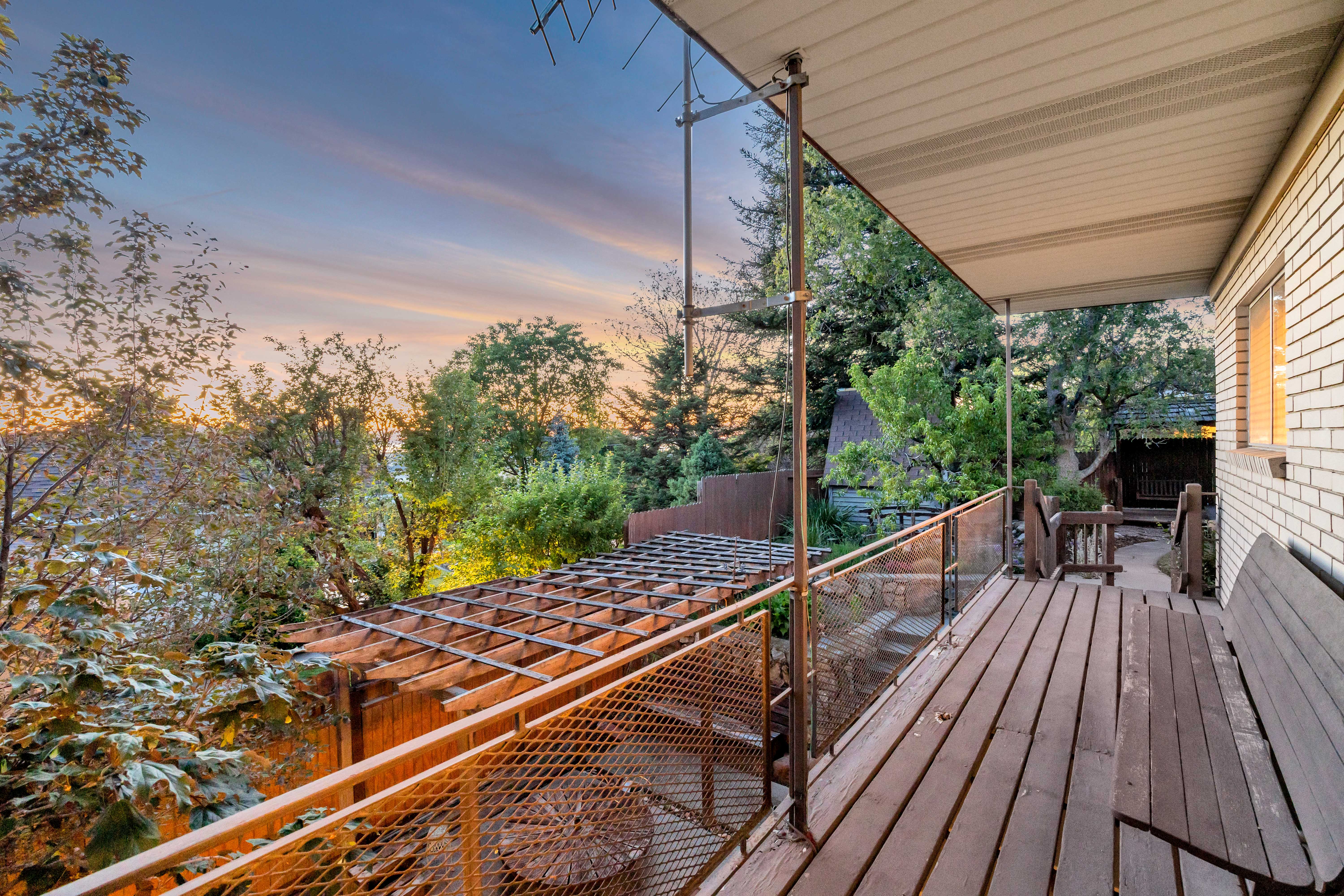 Wood-finish deck with metal and glass railing system