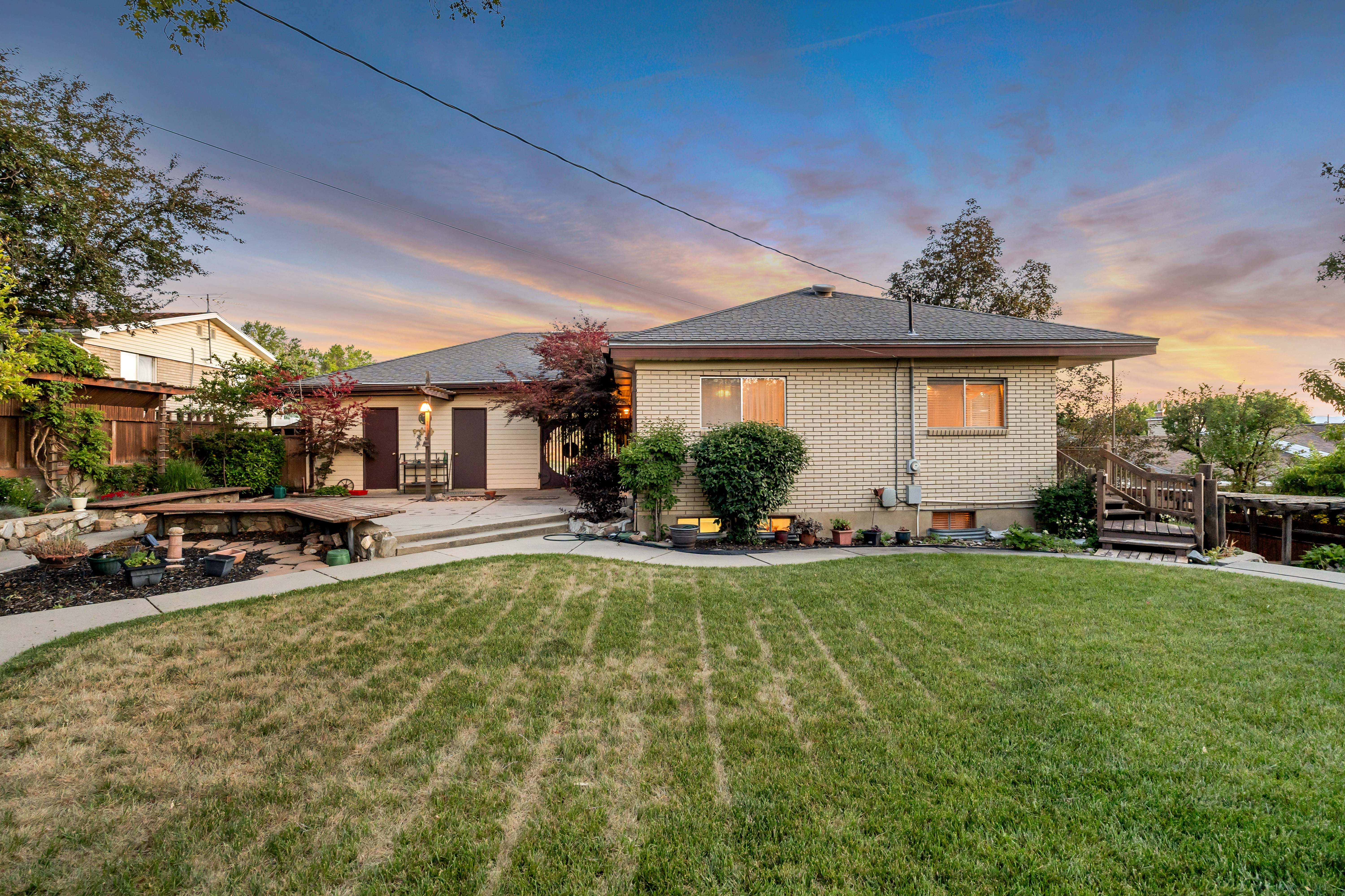 Expansive backyard with a manicured lawn and a concrete patio