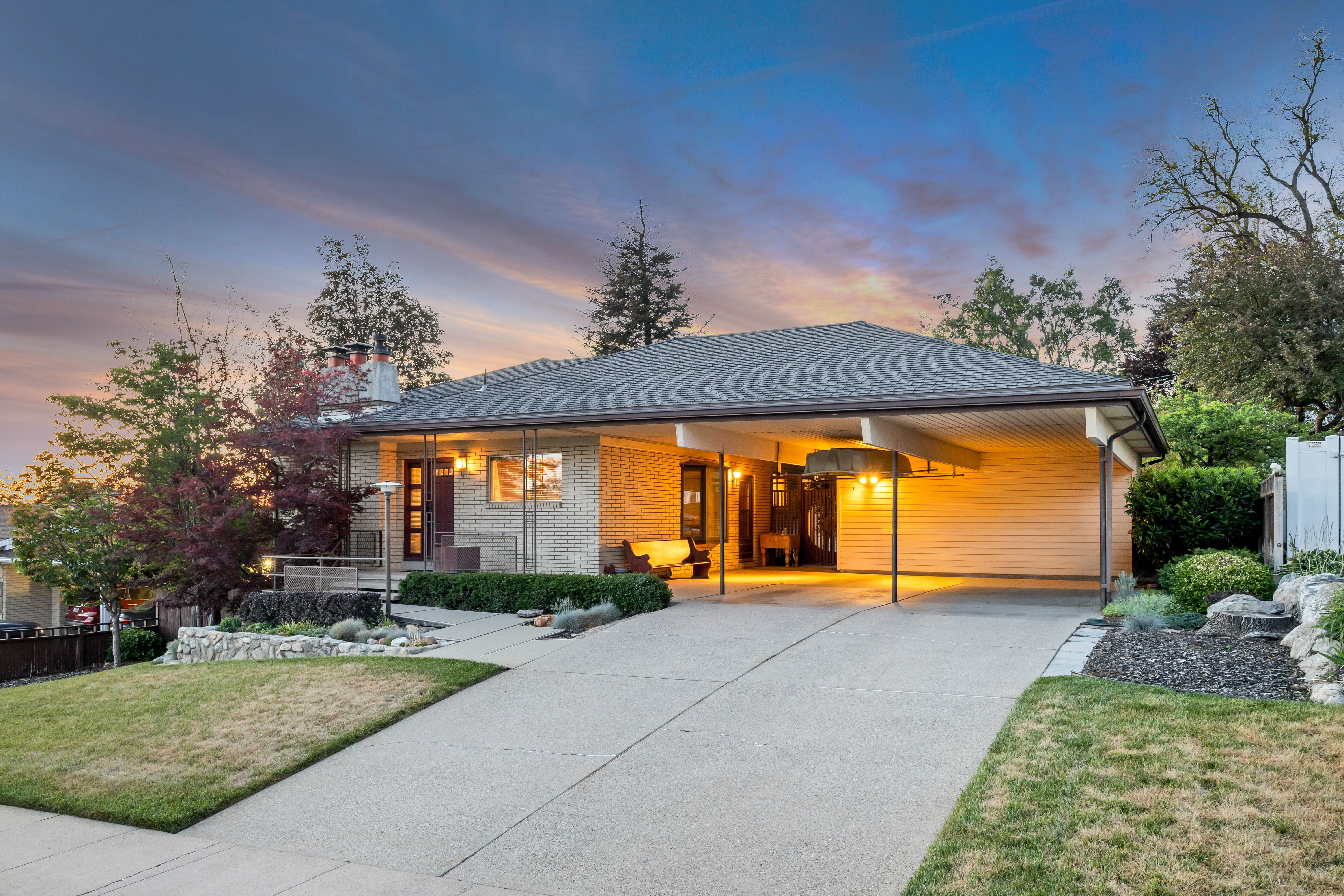 Ranch-style residence featuring a brick facade and a multi-level roofline