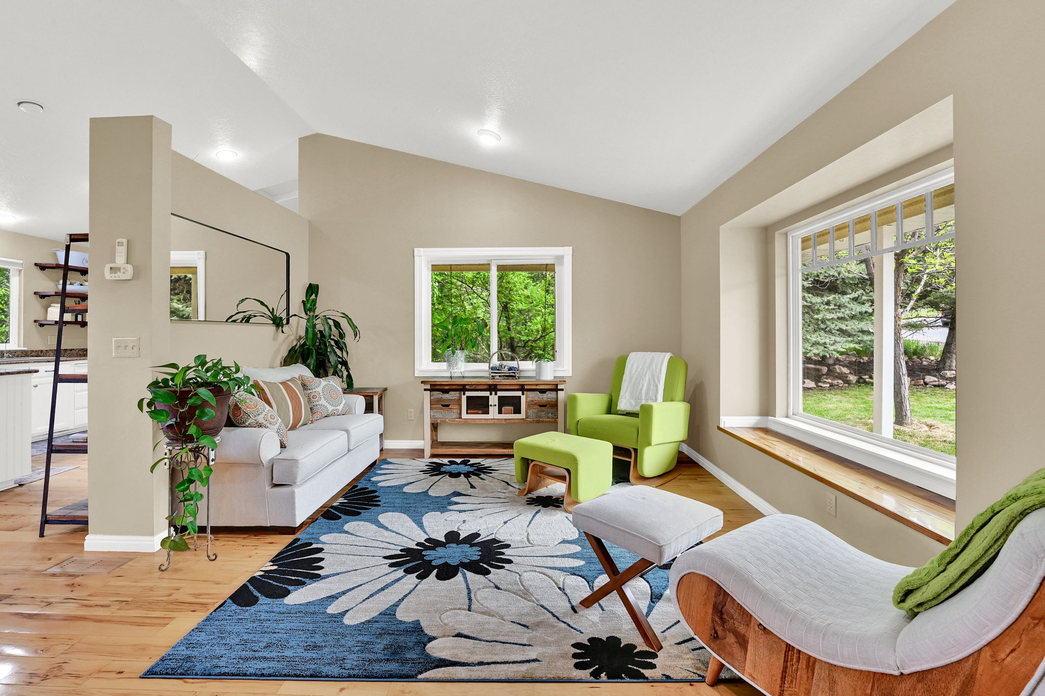 Living area featuring wood-finish flooring, recessed lighting, and a vaulted ceiling