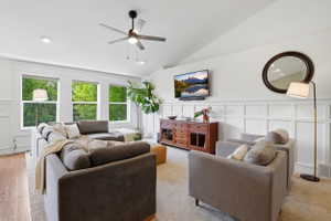 Spacious room featuring vaulted ceilings, recessed lighting, and a modern ceiling fan