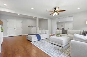 Open-concept living area featuring wood-finish flooring, recessed lighting, and a ceiling fan