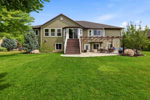 Expansive green lawn bordering a residence with olive-toned siding and white trim