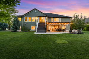 Expansive backyard featuring a lush lawn and a concrete patio