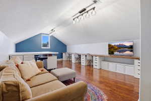 Spacious attic conversion featuring vaulted ceilings and recessed lighting