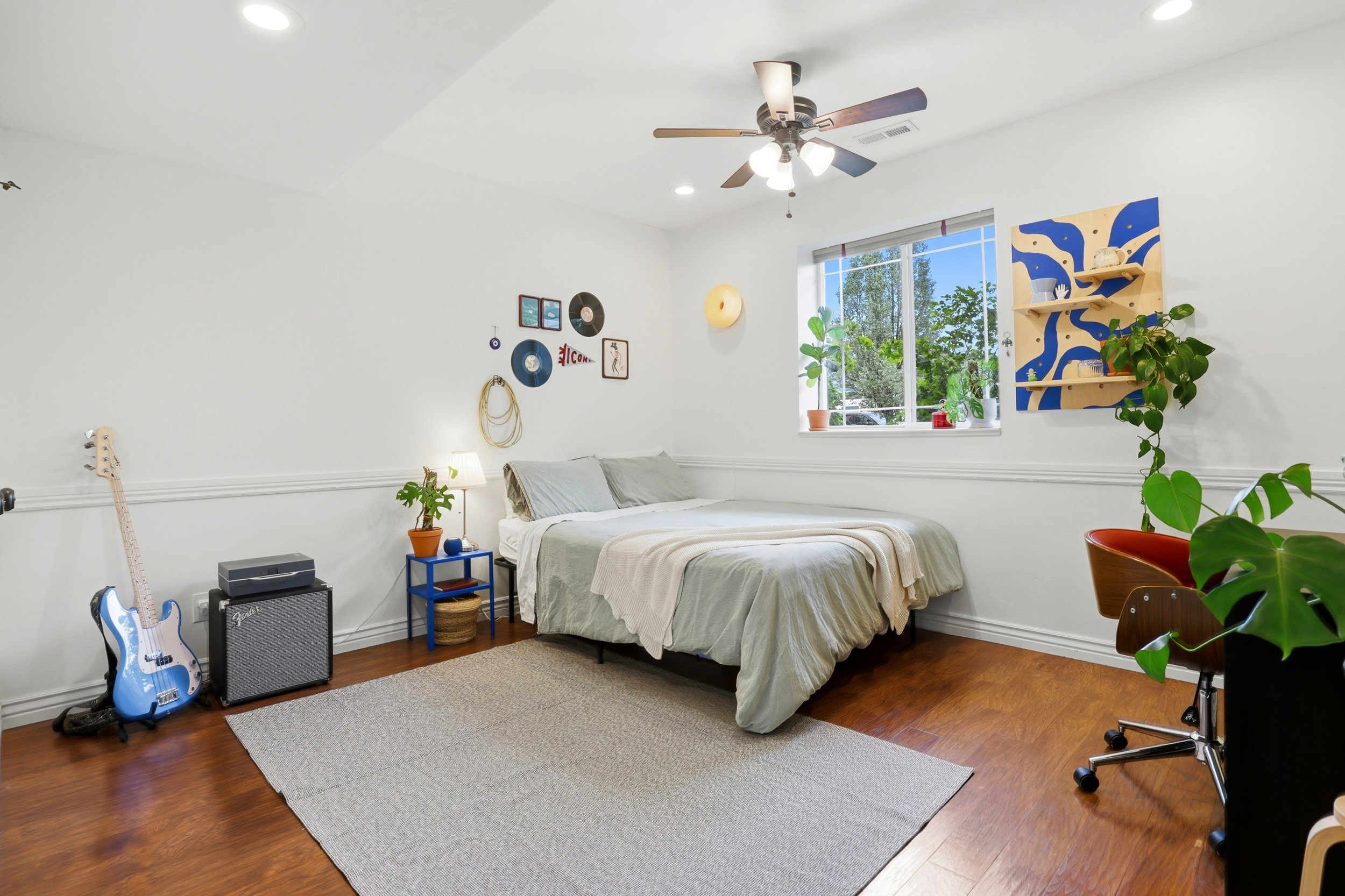 Bright room featuring wood-finish flooring, recessed lighting, and a ceiling fan