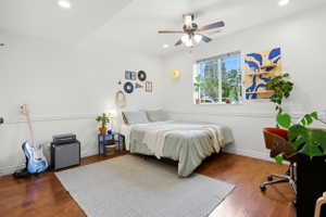 Bright room featuring wood-finish flooring, recessed lighting, and a ceiling fan