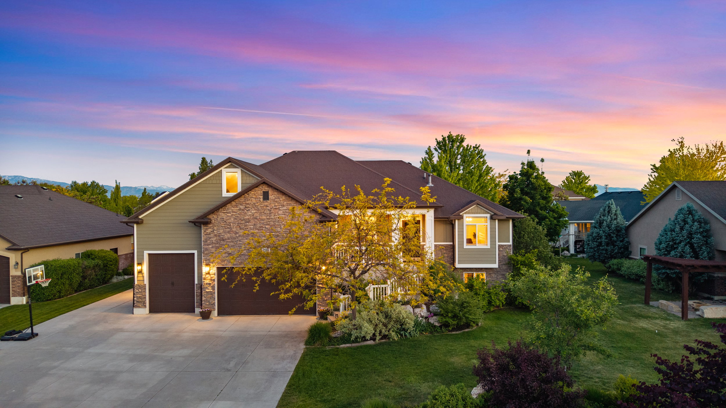 Stone and siding exterior with multiple pitched roofs