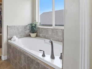 Soaking tub with a tiled surround and brushed nickel fixtures