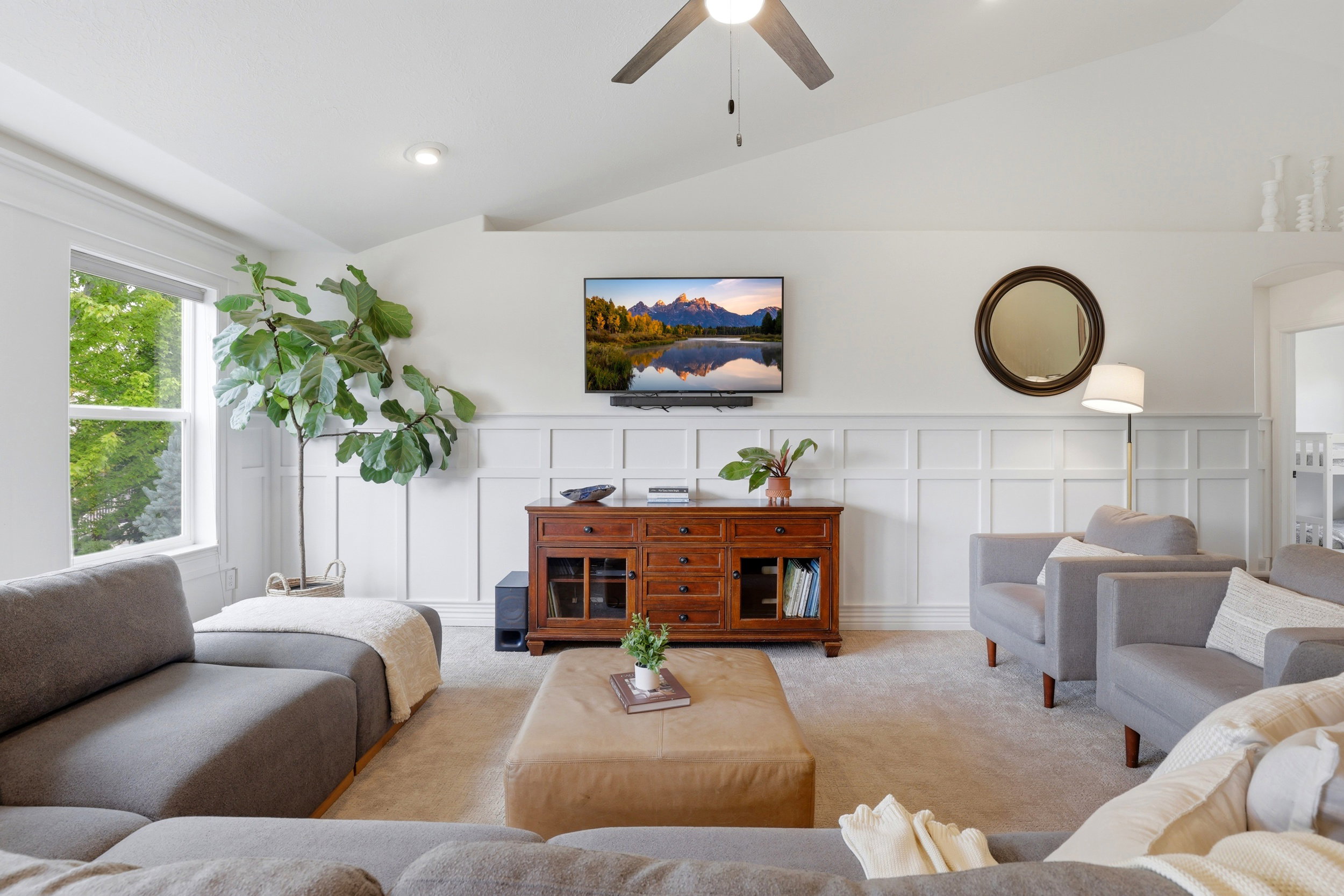 Vaulted ceilings and recessed lighting illuminate this carpeted living space
