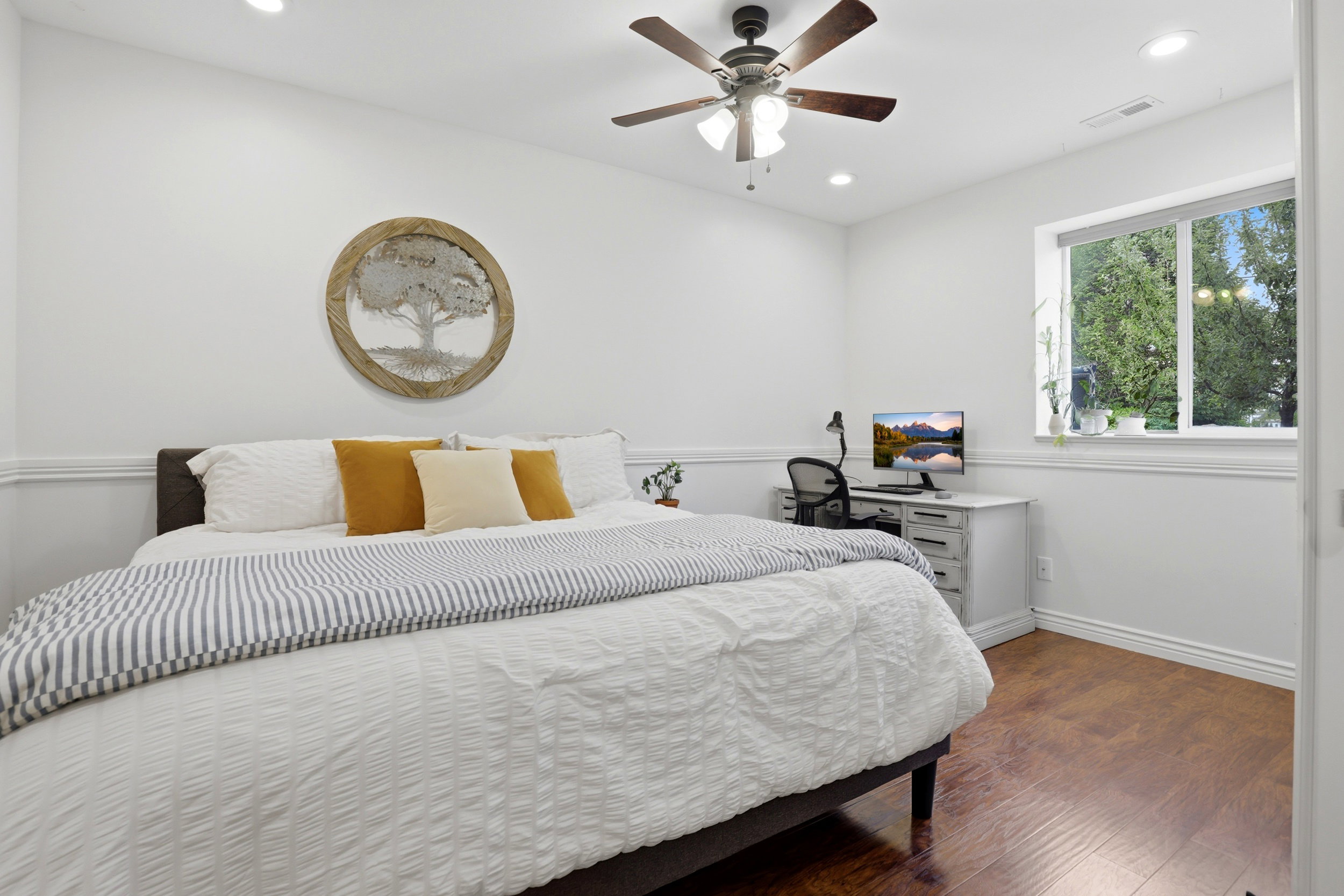 Room featuring wood-finish flooring, recessed lighting, and a ceiling fan with integrated light fixture
