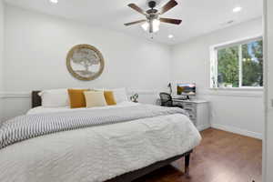 Room featuring wood-finish flooring, recessed lighting, and a ceiling fan with integrated light fixture