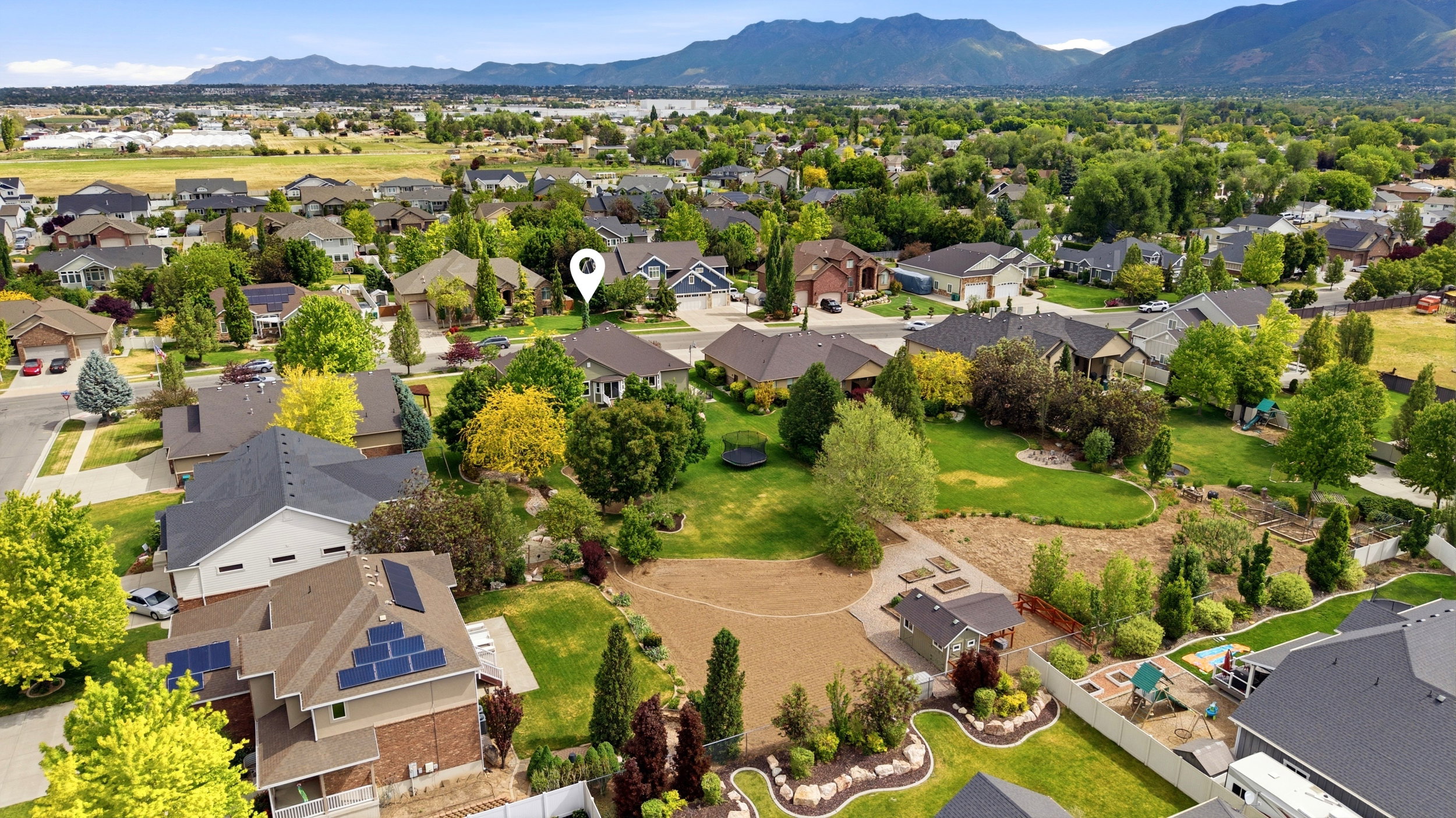 Expansive residential neighborhood with mature landscaping and mountain backdrop