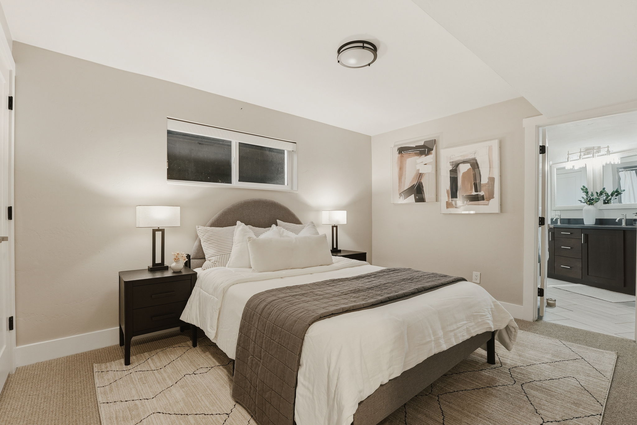 Bedroom featuring a flush-mount ceiling light and a window with white trim
