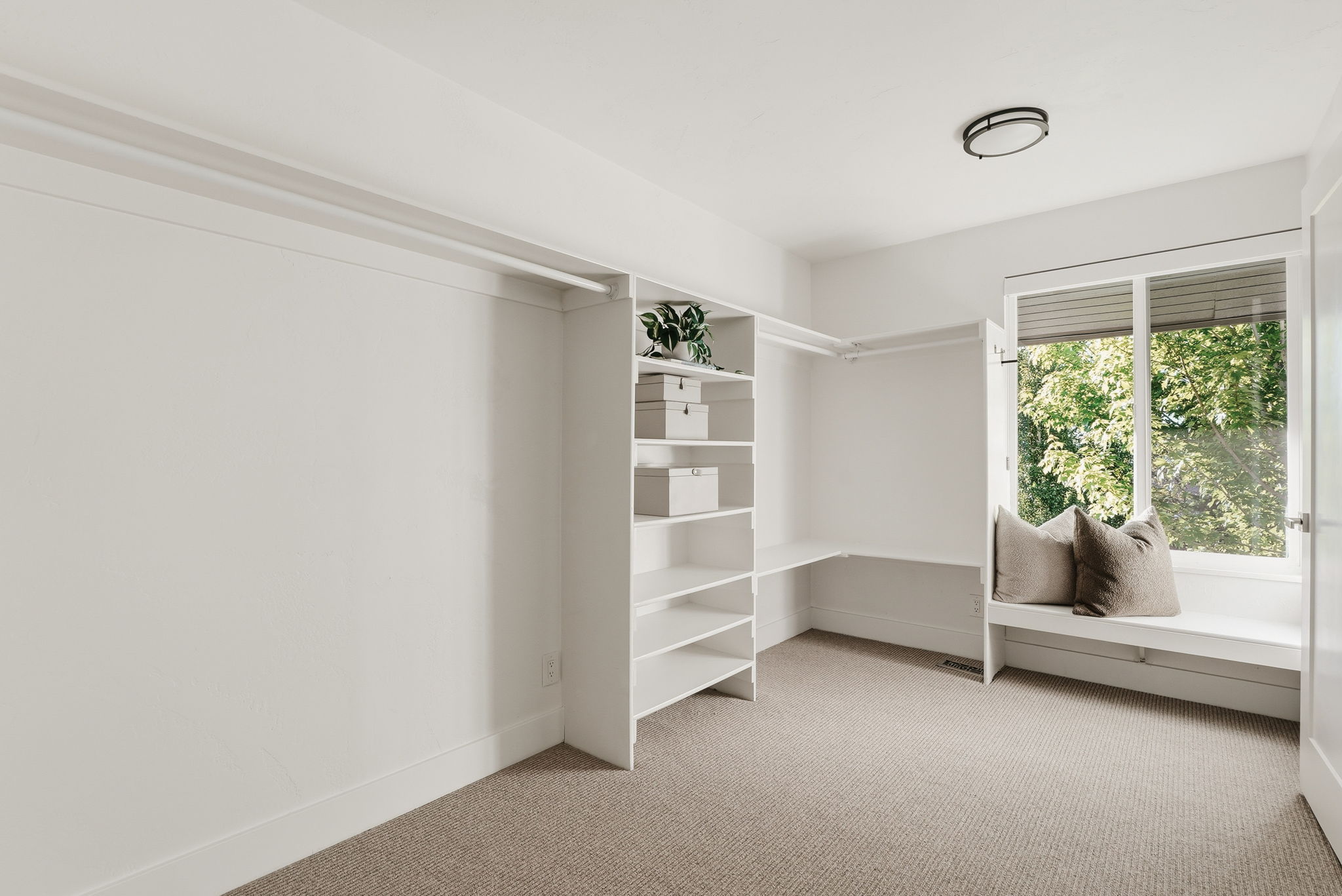 Custom closet system featuring built-in shelving and hanging rods