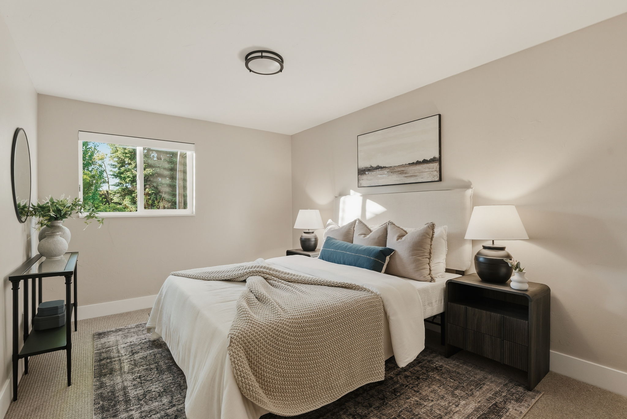 Neutral-toned walls complement the window with outdoor scenery