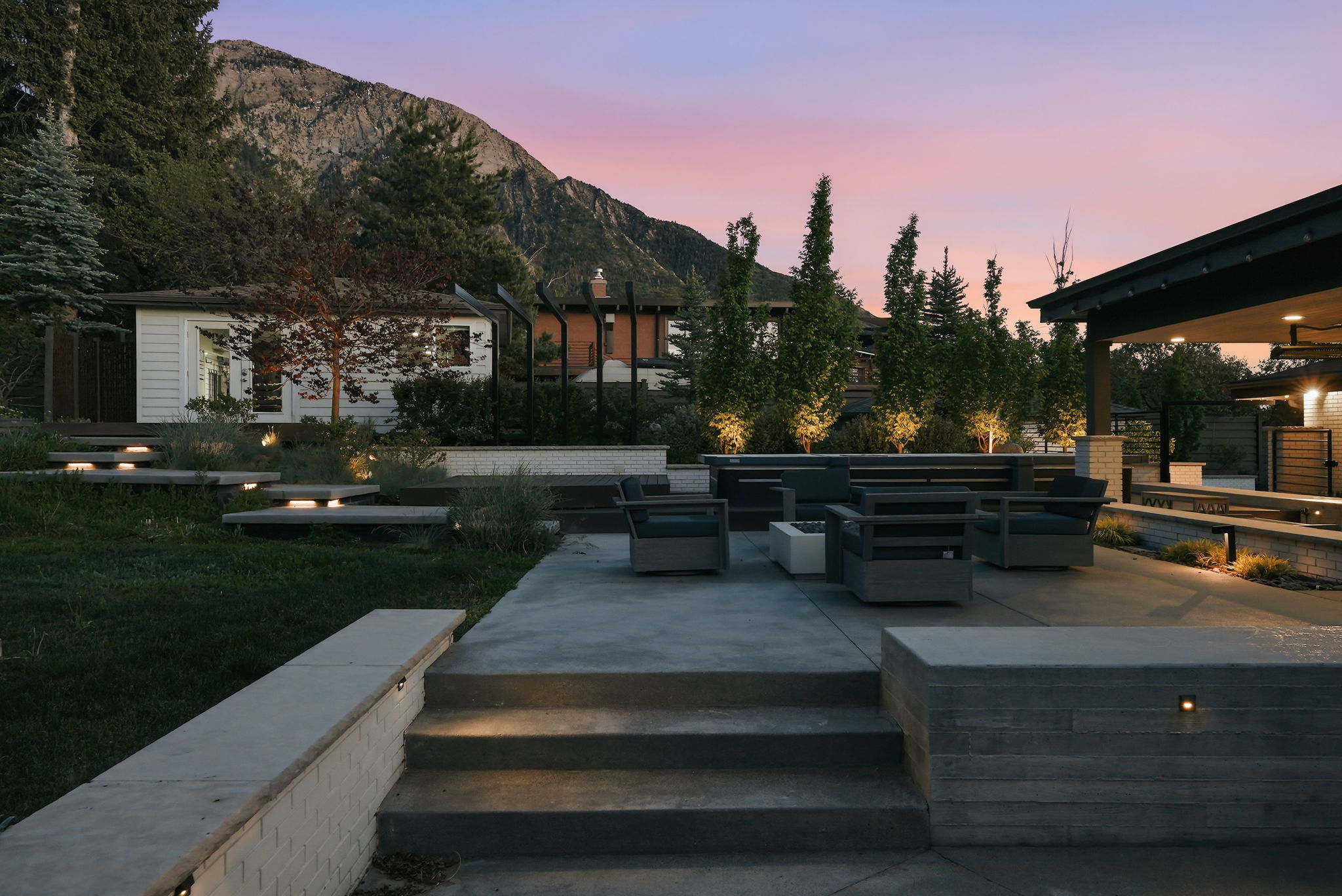 Multi-level concrete patio with integrated lighting and built-in concrete seating