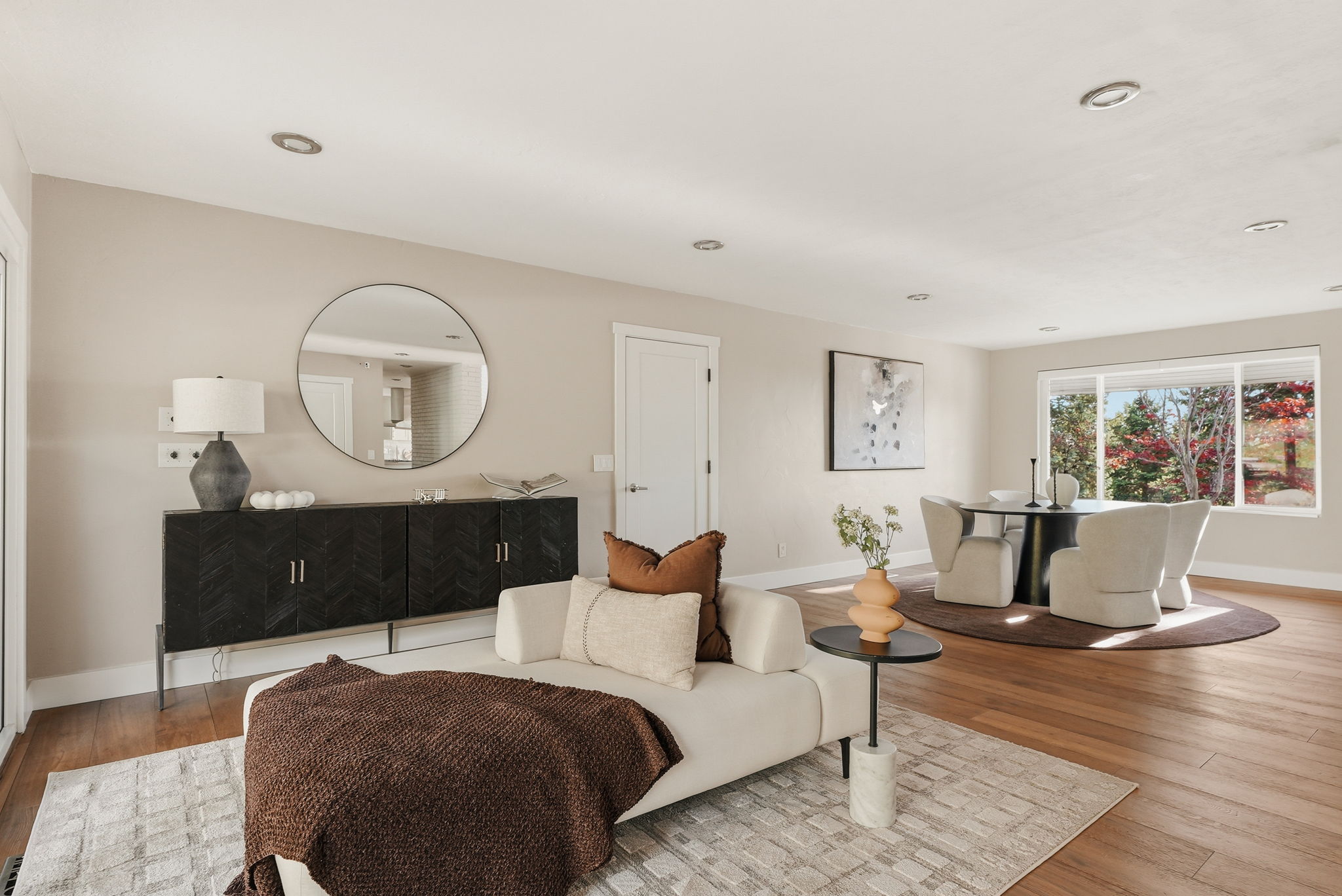 Open-concept living space with wood-finish flooring