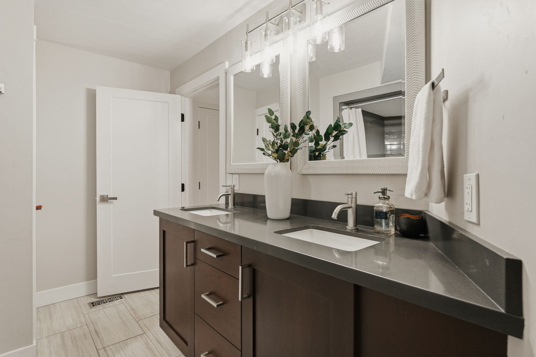 Bathroom featuring a double vanity with dark wood cabinetry and integrated sinks