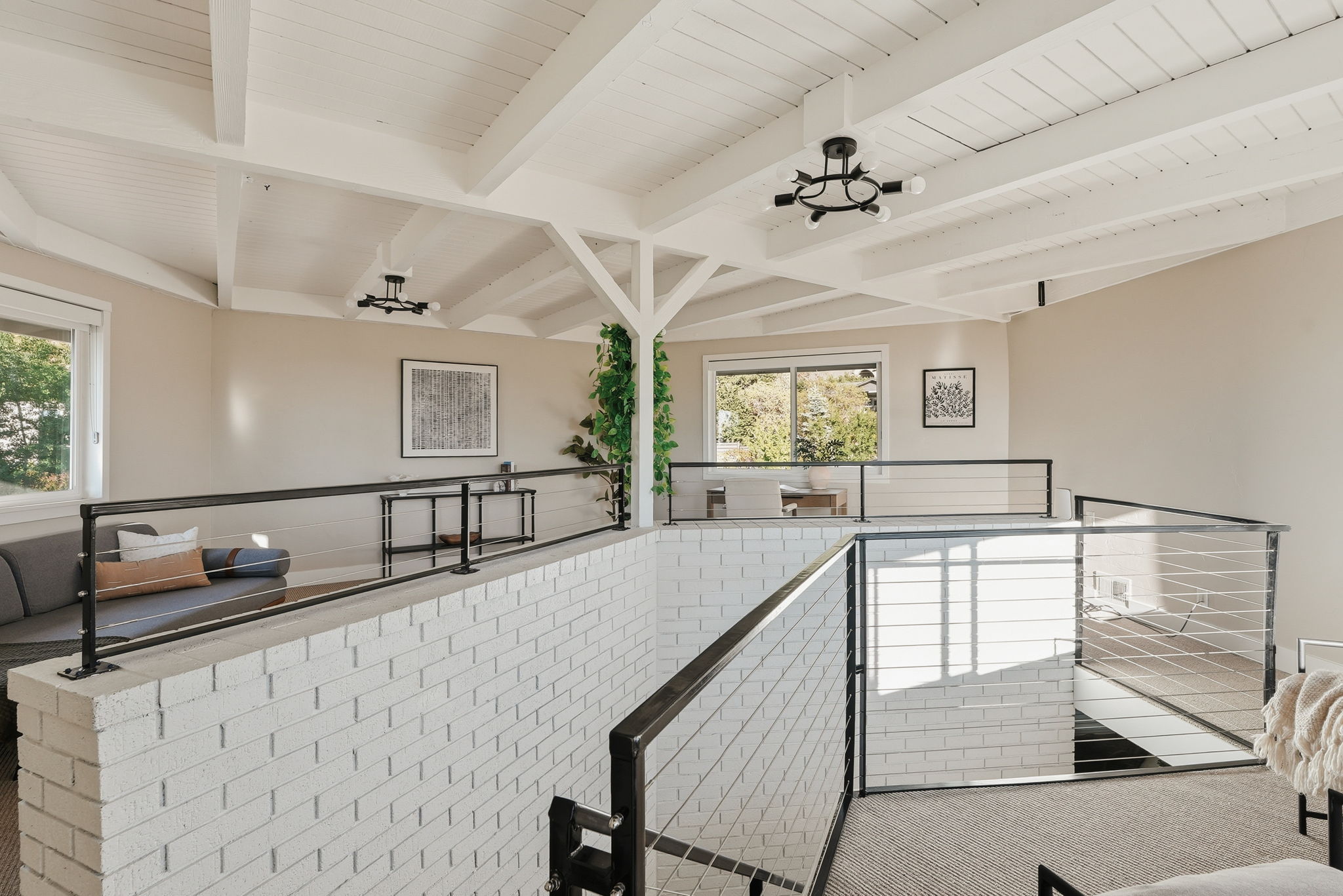 White exposed beam ceiling with modern black light fixtures