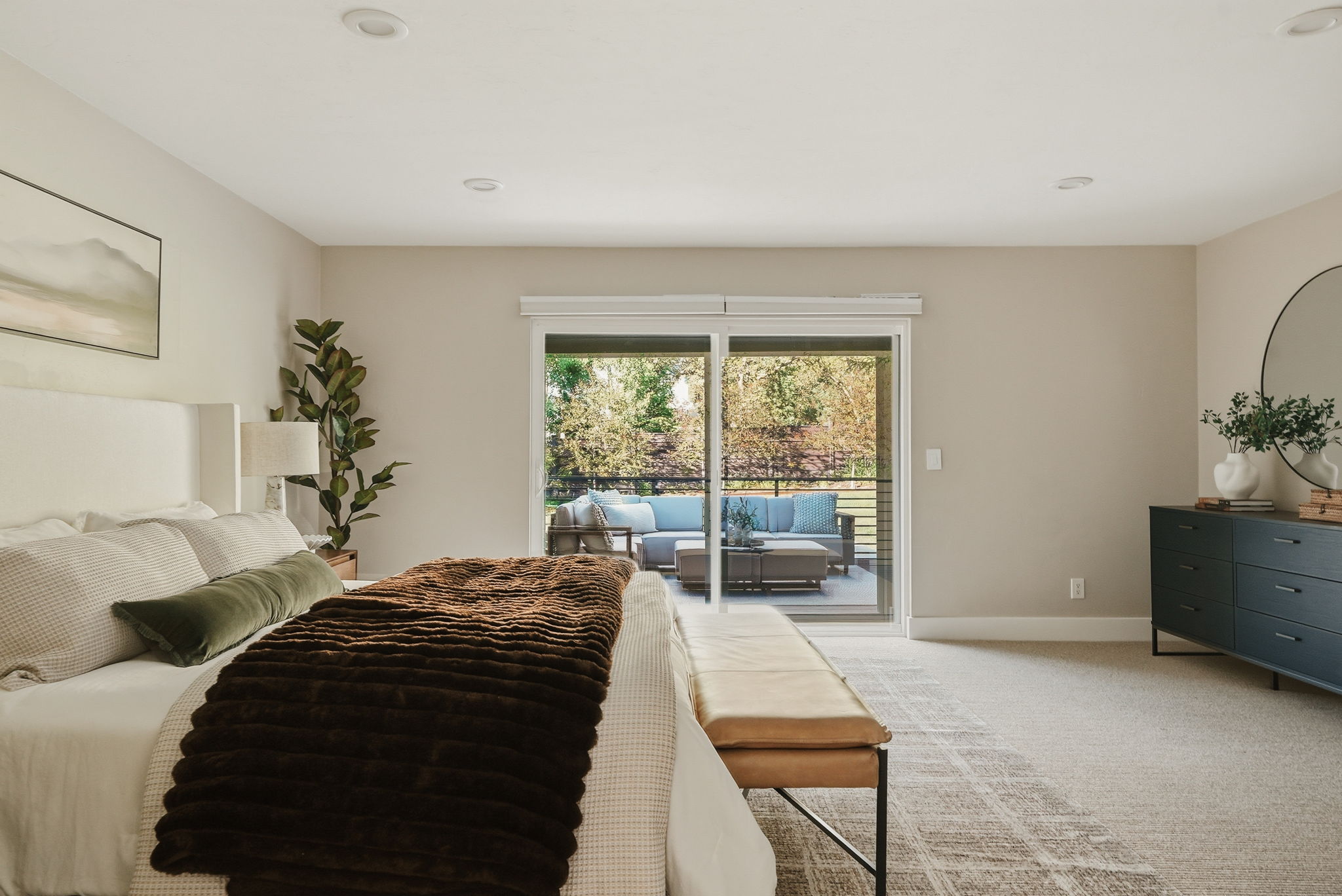 Spacious room featuring light-toned walls and carpeted flooring