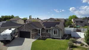 Contemporary single-level residence featuring stone accents and vertical siding